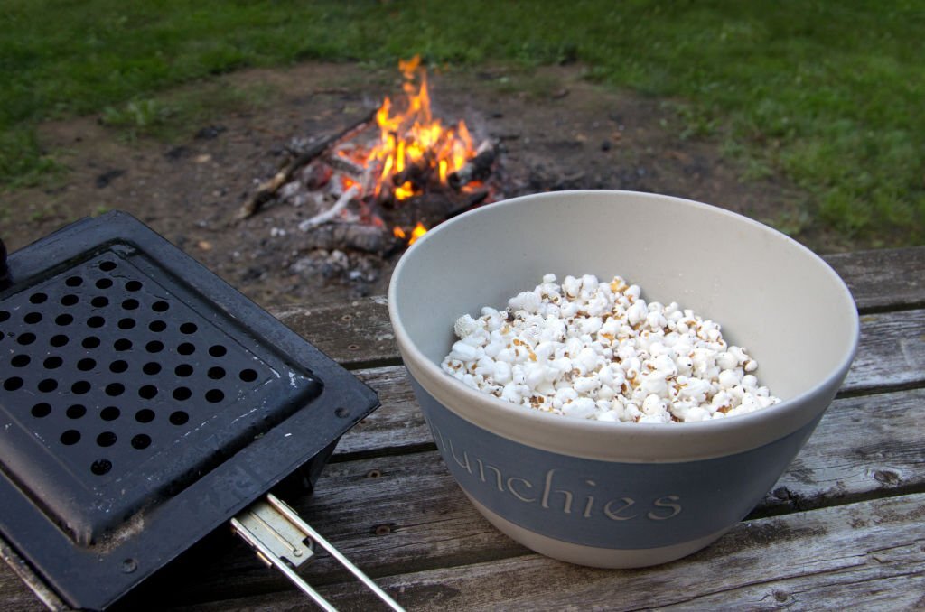 making pop corn with just a kettle on a camping trip 